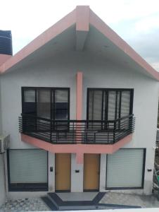 a house with a balcony on top of it at Suryaansh in Pālghar