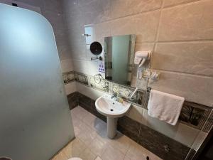 a bathroom with a sink and a mirror at PRIMOTEL Suites As Salamah in Jeddah