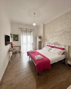 a bedroom with a large bed with a red blanket on it at Pigneto dreams rooms in Rome