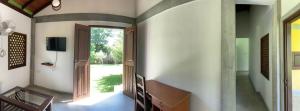 an open hallway with a door and a television at Villa De Lagoon View in Tangalle