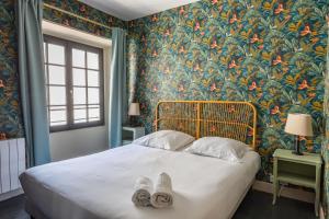 En eller flere senge i et værelse på Les marmousets, 5 minutes du Zoo