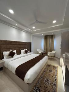 a bedroom with a large bed in a room at Hotel President Agra near Taj mahal in Agra