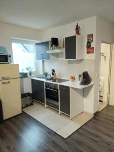 a kitchen with a refrigerator and a counter top at Lech Appartement in Landsberg am Lech +11 photos
