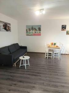 a living room with a couch and a table at Lech Appartement in Landsberg am Lech