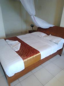 Ein Bett oder Betten in einem Zimmer der Unterkunft QUINTEN HOTEL KISUMU