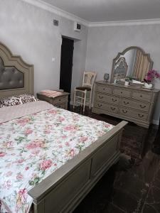 a bedroom with a bed and a dresser and a mirror at Residence Manu Targu Neamt in Târgu Neamț