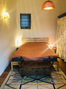a bedroom with a bed with a wooden head board at La Bergerie en Cévennes in Mialet