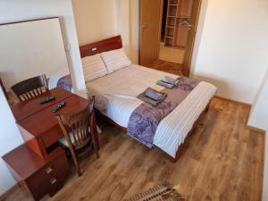 a small bedroom with a bed and a desk at Mountain View Resort - Apartment B45 in Bansko +14 photos