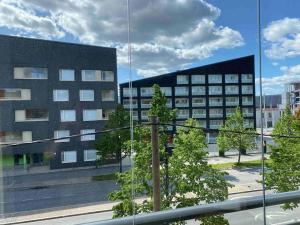 een uitzicht op een gebouw met bomen ervoor bij Beautiful apartment - own parking space included in Vantaa