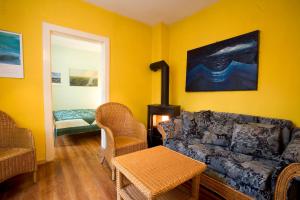 a living room with a couch and a stove at Hotel Reingard in Wismar