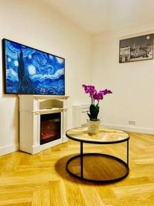a living room with a table with flowers on it at An Exceptional Apartment, 20 Min Paris, 10 Min Orly Airport, 30 Min Disney, 25 Min Versailles, Parking free in Antony