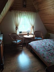 a bedroom with a bed and a table and a window at Beba in Heřmanovice