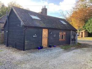 a small black building with a door and windows at Barn 5 in Vigo Village