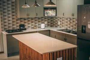 a kitchen with a island in the middle of it at Tshikwalo Game Lodge in Klipdrift