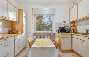 a kitchen with a table and chairs and a window at Lovely Apartment In Jena With Wifi in Jena