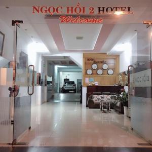 a lobby of a hotel with a bed and clocks on the wall at Khách sạn Ngọc Hồi 2 in Buôn Kô Sir