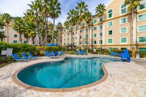a swimming pool in front of a building at Resort Hotel family Condo near Disney parks - Lake Buena Vista in Orlando