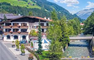 a building next to a river with a bridge at Gorgeous Studio In Kirchberg With House A Mountain View in Kirchberg in Tirol