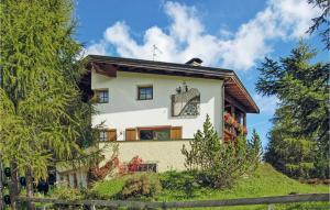 una casa blanca en una colina con árboles en Amazing Apartment In Obernberg With 3 Bedrooms And Wifi, en Obernberg am Brenner