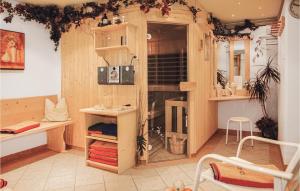 カップルにあるBeautiful Apartment In Kappl With 3 Bedrooms, Sauna And Wifiの木製の壁の客室と棚付きの客室を提供しています。
