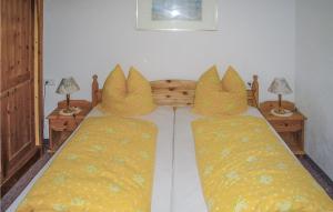 a bedroom with a bed with yellow pillows at Nice Apartment In Ehrwald With 2 Bedrooms And Wifi in Ehrwald