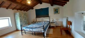 a bedroom with a bed and a table and a window at Antica Dimora in Bagnore