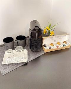 a coffee maker sitting on top of a counter with some cups at Hotel Elisei in Nuremberg