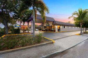 a building with a yellow hose in a parking lot at Days Inn by Wyndham St. Petersburg Central in St Petersburg