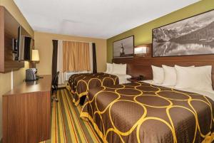 a hotel room with two beds and a television at Super 8 by Wyndham Superior WI in Superior