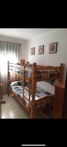 two bunk beds in a room with a cat sleeping on them at Beachfront 3 Bedroom Family Apartment in Matalascañas