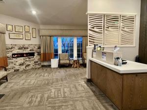 a lobby of a hotel with a reception desk and a dog at Best Western Country Inn in Fortuna