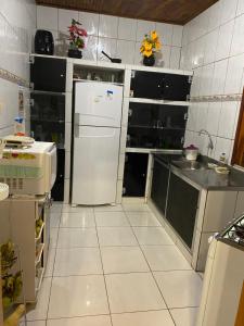 a kitchen with a refrigerator and a sink at casa pedacinho do morro in Bom Jesus da Lapa +28 photos