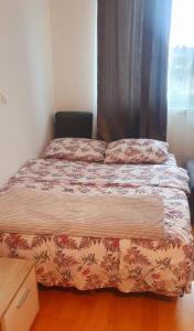 a bed in a room with a window and a bedspread at Studio Apartman Maša Kupres in Kupres