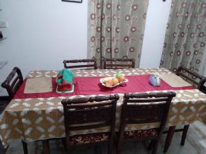 a table with a plate of fruit on top of it at Rock Cascade tourist home in Polonnaruwa