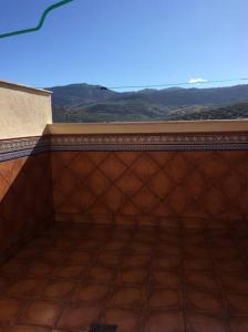 a room with a wall with a view of the mountains at Alojamientos el cuco Luque in Luque