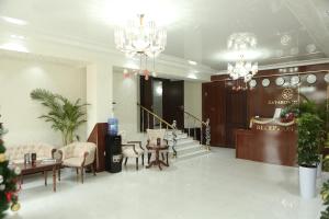 a lobby with a waiting area with chandeliers at Za'faron Hotel in Jizzax