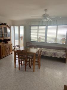 a dining room with a table and chairs and a bed at Casa Teresina in Castellabate