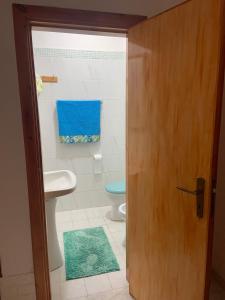 a bathroom with a toilet and a sink and a door at Casa Teresina in Castellabate