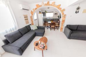 a living room with two couches and a table at 2 bed, Kapparis, Trinidad - 2A in Paralimni