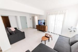 a living room with two couches and a tv at 2 bed, Kapparis, Trinidad - 2A in Paralimni