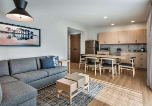 a living room and kitchen with a couch and a table at Hyatt Place Kent Narrows And Marina in Grasonville