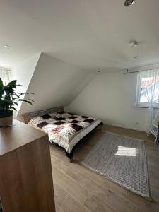 a bedroom with a bed in the corner of a room at Ferienwohnung gemütlich modern in Langenzenn