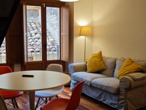 a living room with a couch and a table at Cal Tuc in Camprodon