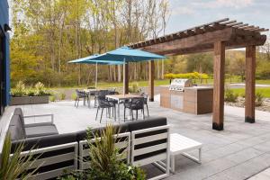 a patio with a table and chairs and an umbrella at Hampton Inn Hornell in Hornell