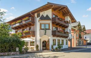 a building with balconies and flowers on it at Cozy Apartment In Kirchberg With Kitchen in Kirchberg in Tirol