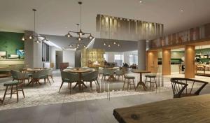 a lobby with tables and chairs and a kitchen at Homewood Suites By Hilton Nashville Downtown The Gulch in Nashville