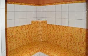 a shower with brown and white tiles on the wall at Cozy Apartment In Kirchberg With Kitchen in Kirchberg in Tirol