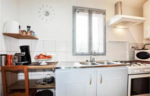 a white kitchen with a sink and a microwave at Nice Home In Caudis-de-fenouillde With House A Panoramic View in Caudiès-de-Fenouillèdes