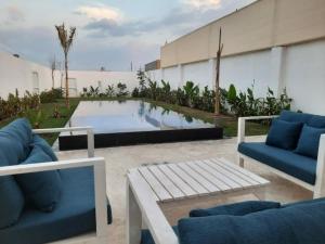 a patio with couches and a pool in front of a building at شاليه مزدانة in Makkah