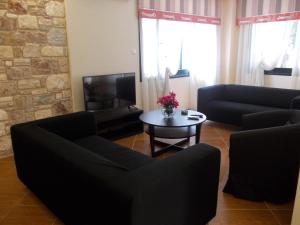 a living room with two couches and a coffee table at Oneiro Studios in Loutra Edipsou